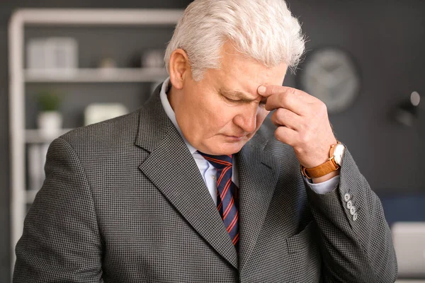 Sad fired mature man in office