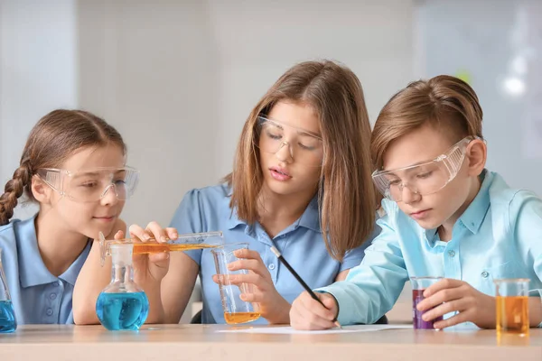 Pupils at chemistry lesson in classroom