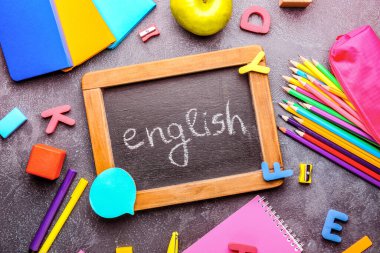 Koyu arkaplan üzerinde ENGLISH ve kırtasiye içeren tebeşir tahtası