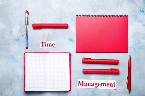 Stationery and text TIME MANAGEMENT on color background