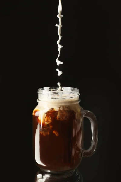 Pouring Milk Cold Coffee Mason Jar Dark Background — Stock Photo, Image