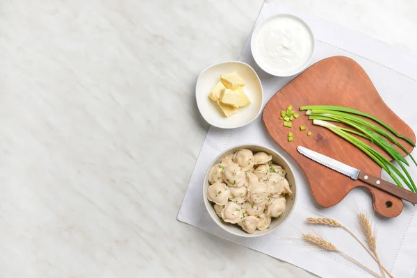 Bowl Tasty Dumplings Butter Sauce Green Onion Table — Stock Photo, Image