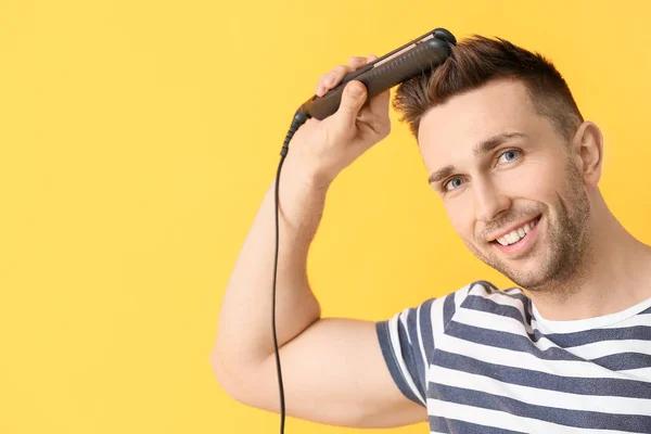 Handsome Young Man Flattening Iron Color Background — Stock Photo, Image