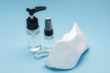 Renk arkaplanına dezenfektanlar ve tıbbi maske
