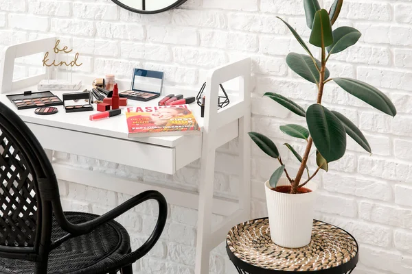 Set of decorative cosmetics on table of makeup artist in room