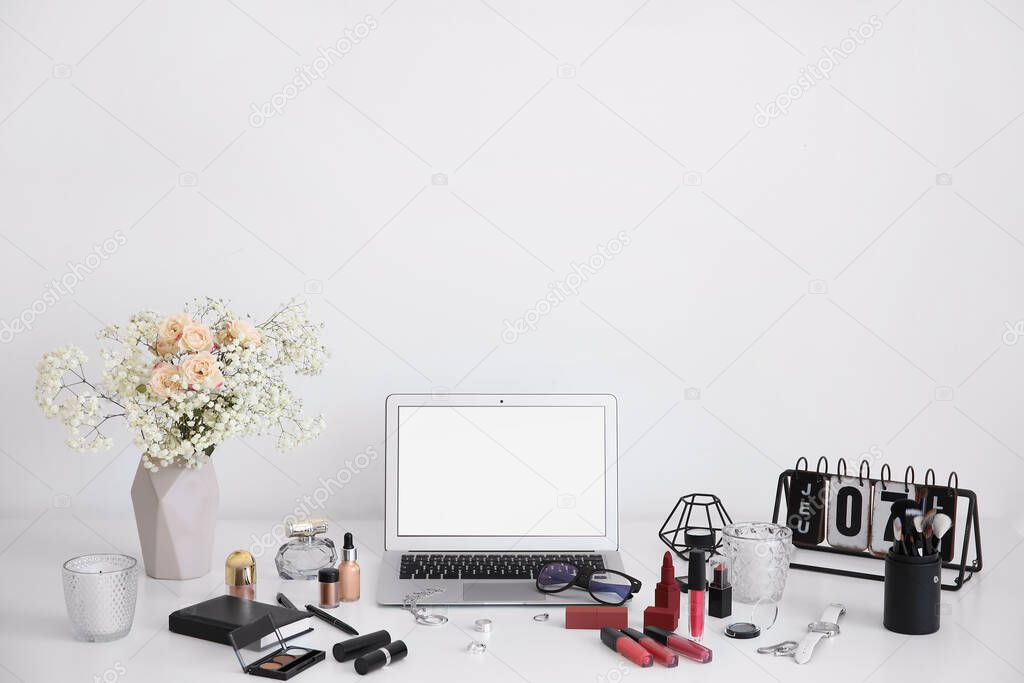 Workplace of professional makeup artist with laptop