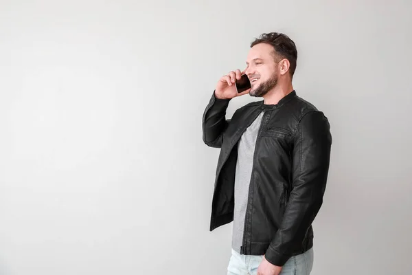 Stylish Man Talking Mobile Phone Light Background — Stock Photo, Image