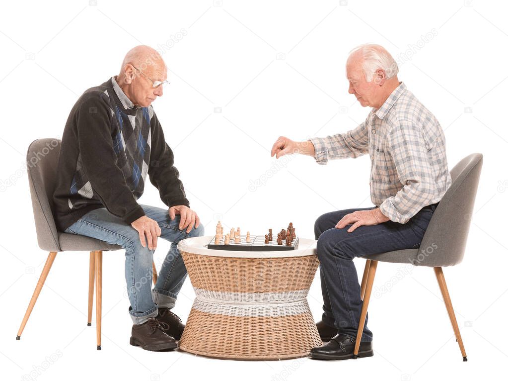 Portrait of elderly men playing chess on white background