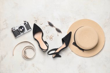 Plaj şapkalı, ayakkabılı, fotoğraf makineli ve arka planda aksesuarlı yaz kompozisyonu