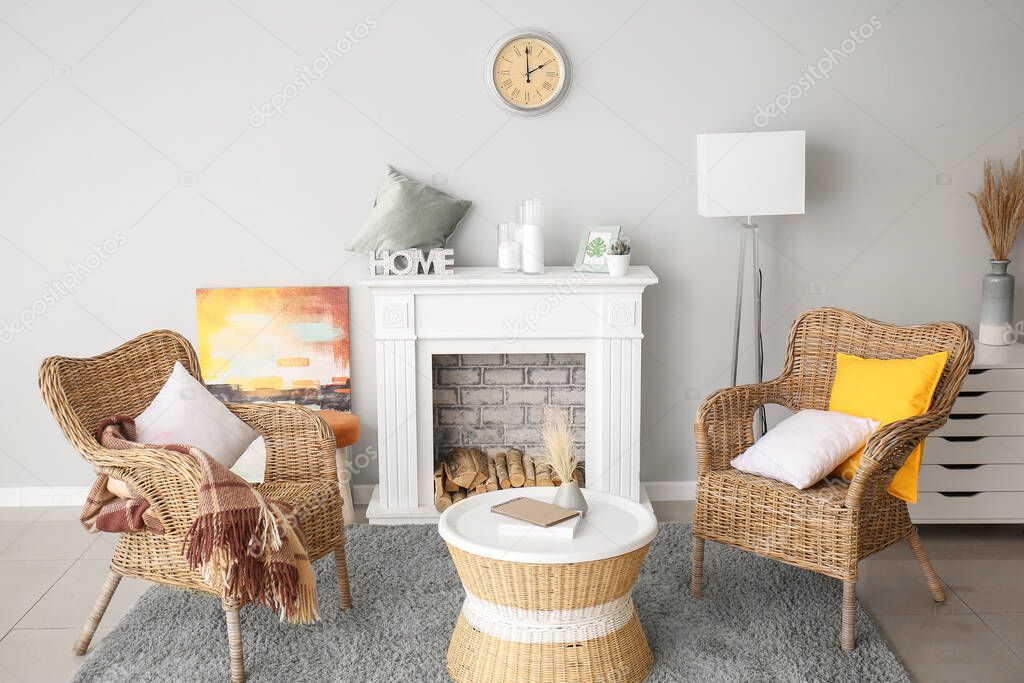 Interior of modern room with comfortable armchairs and fireplace