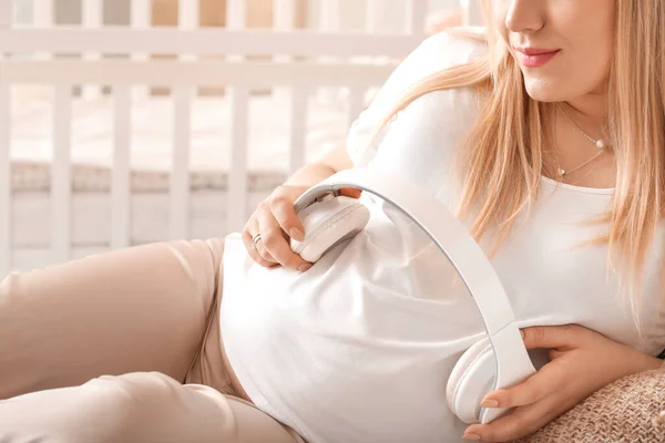 Beautiful Pregnant Woman Putting Headphones Her Belly Bedroom — Stock Photo, Image