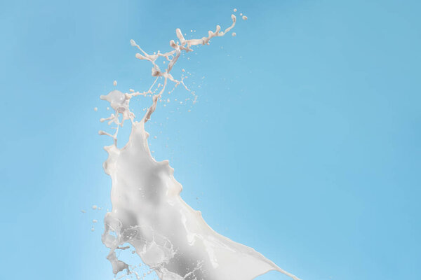 Splash of milk on color background