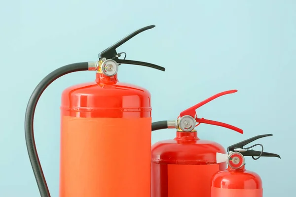 Fire extinguishers on color background