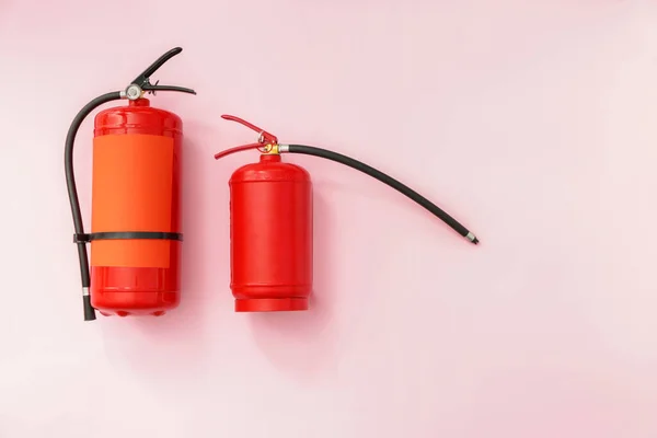 Fire extinguishers on color background