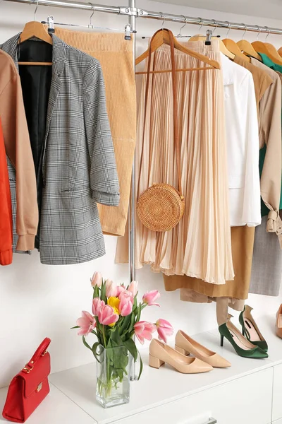 Modern wardrobe with stylish spring clothes and accessories