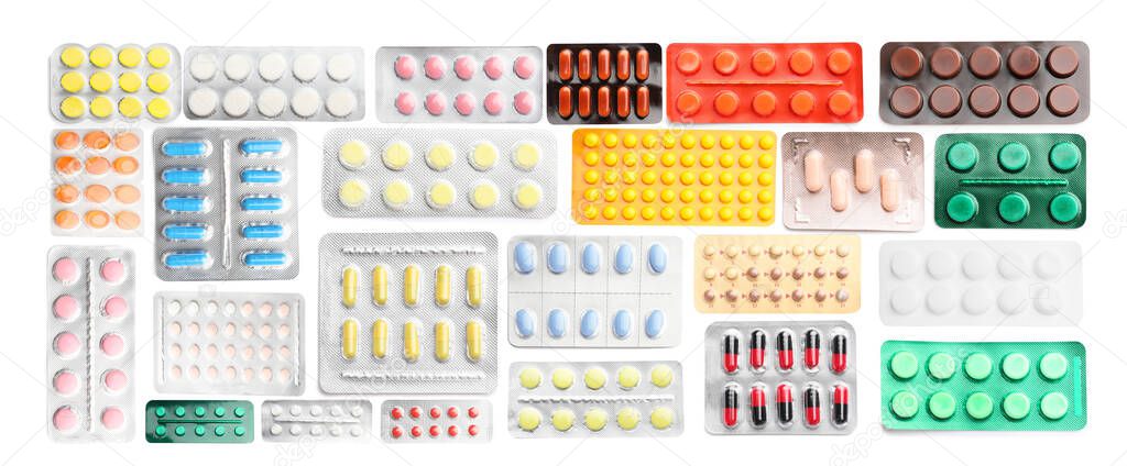 Many different blisters with pills on white background