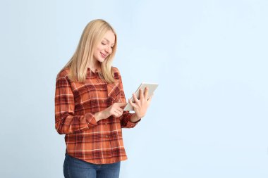 Renkli tablet bilgisayarlı güzel bir genç kadın.