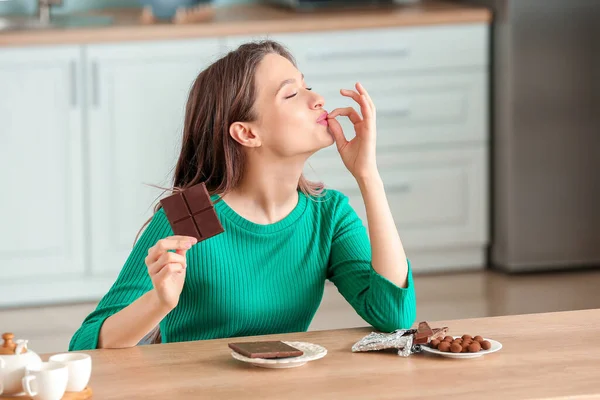 Beautiful Young Woman Eating Chocolate Kitchen — Stock Photo, Image