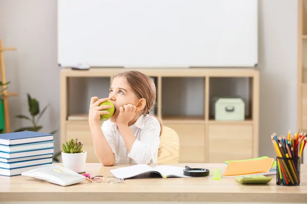 Cute Little Schoolgirl Eating Apple Classroom — Stock Photo, Image