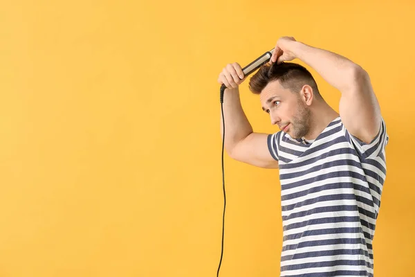 Handsome Young Man Flattening Iron Color Background — Stock Photo, Image