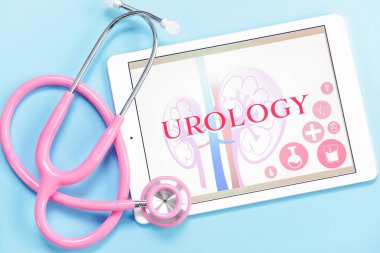 Tablet computer with text UROLOGY and stethoscope on color background clipart