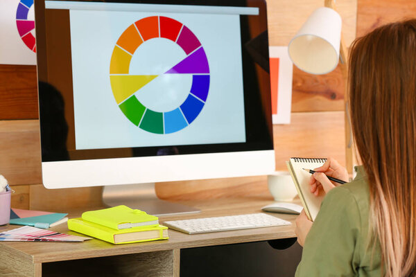 Young designer working on computer at home