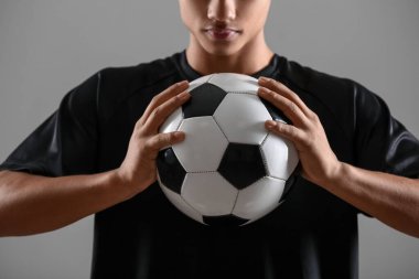 Gri arka planda genç bir Afro-Amerikan futbolcu, yakın plan