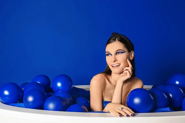 Portrait Fashionable Young Woman Air Balloons Sitting Bathtub Blue Background — Stock Photo, Image