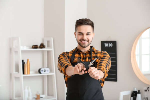 Portrait of male hairdresser in salon