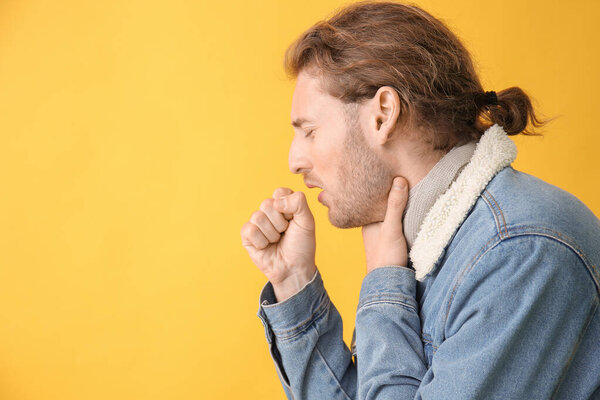 Ill young man on color background