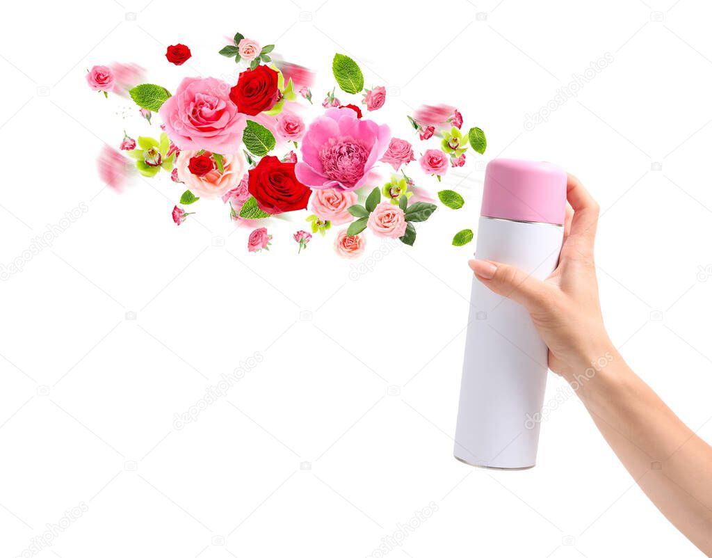 Woman spraying floral air freshener on white background