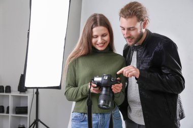 Profesyonel fotoğrafçı stüdyoda model resimleri gösteren