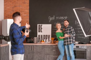Photographer working with young couple in studio