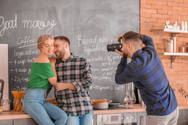Photographer working with young couple in studio