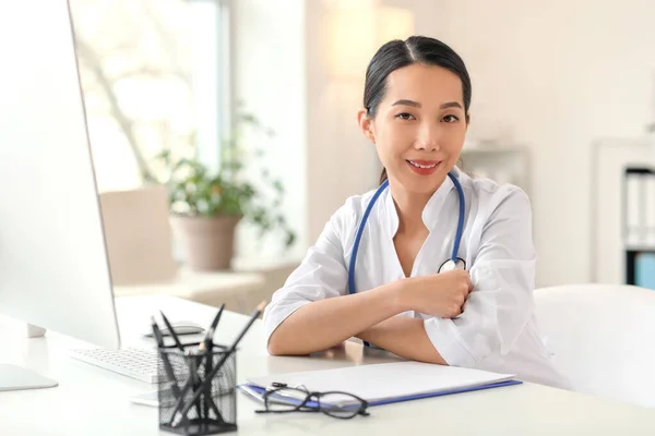 Female Asian doctor working in clinic