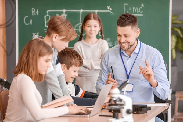 Teacher conducting physics lesson in classroom