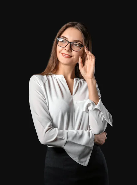 Young adult woman in formal clothes is indoors against grey background  15408490 Stock Photo at Vecteezy