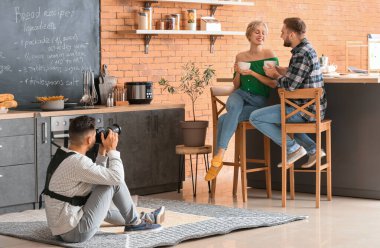 Photographer working with young couple in studio