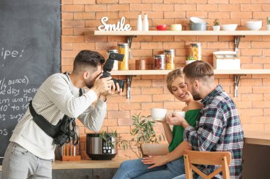 Photographer working with young couple in studio