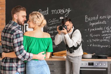 Photographer working with young couple in studio