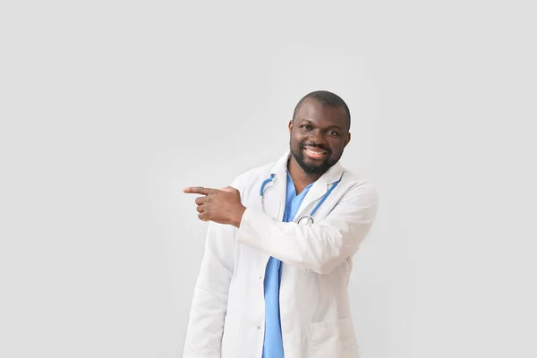 African American Doctor Pointing Something Light Background — Stock Photo, Image