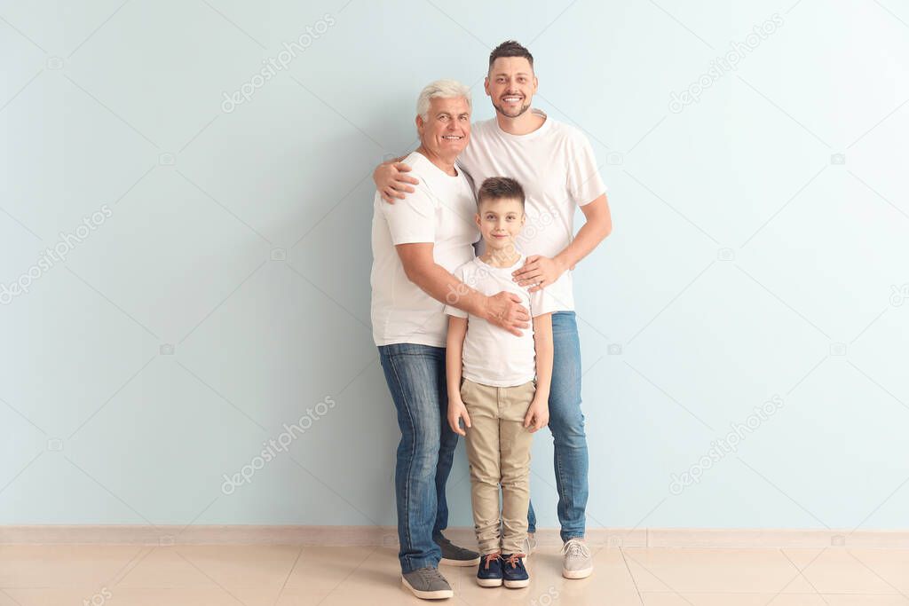 Man with his father and son near color wall