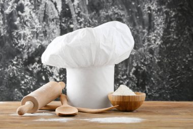 Aşçının şapkası ve mutfak gereçleri grunge 'a karşı masada.