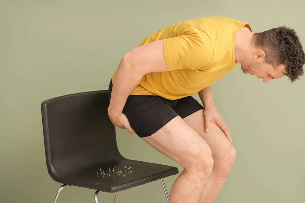 Young Man Chair Drawing Pins Color Background Hemorrhoids Problem — Stock Photo, Image