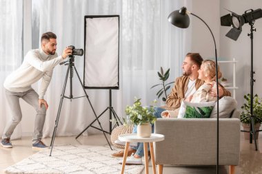 Photographer working with young couple in studio