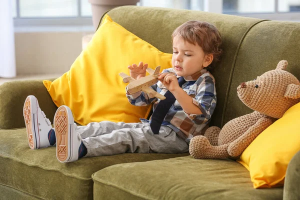 Cute Little Boy Wooden Airplane Sitting Sofa Home — Stock Photo, Image