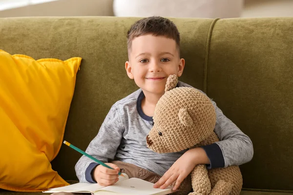 Cute Little Boy Teddy Bear Notebook Sitting Sofa Home — Stock Photo, Image