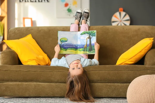 Cute Little Girl Reading Book Sofa Home — Stock Photo, Image