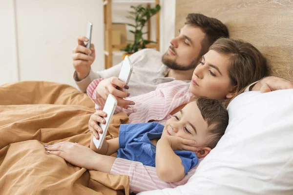 Happy Family Mobile Phones Bedroom — Stock Photo, Image