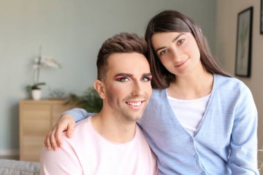 Portrait of happy transgender couple at home clipart